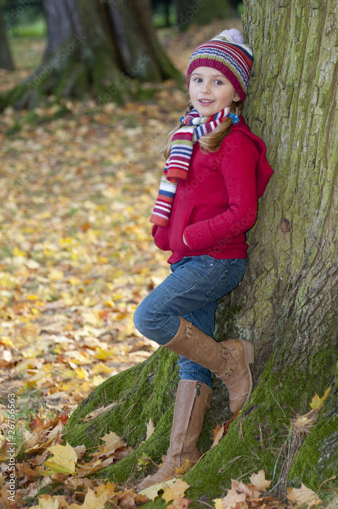 Little fashion girl in autumn park