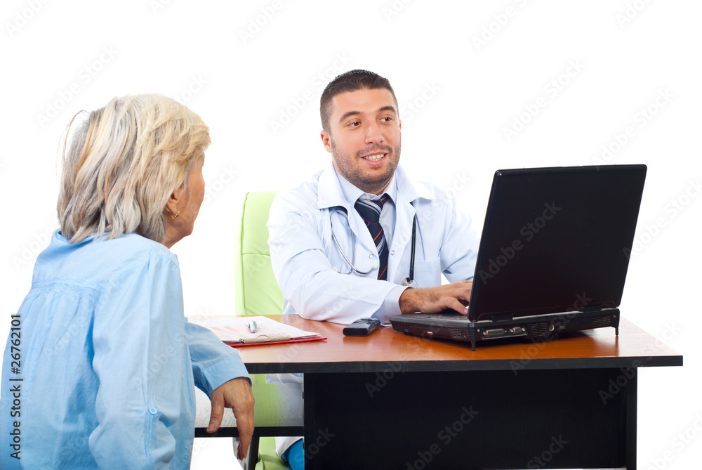 Doctor using laptop while converse with patient Doctor using laptop while converse with patient