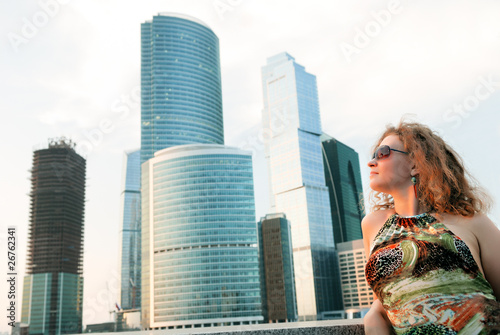 Businesswoman near modern buildings