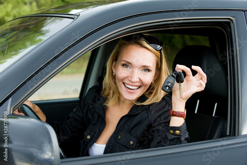 Beautiful young happy woman in the new car with keys - outdoors © Valua Vitaly