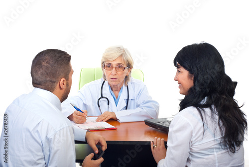 Doctor having conversation with young couple