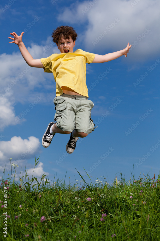 Boy jumping, running against blue sky Boy jumping, running against blue sky