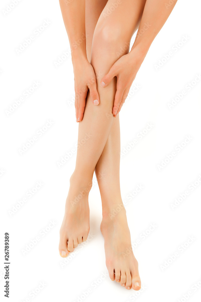 Woman massaging legs sitting on white background Woman massaging legs sitting on white background