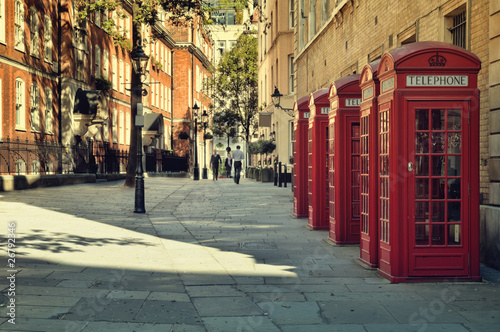 Street with traditional red Phone Boxes, London.