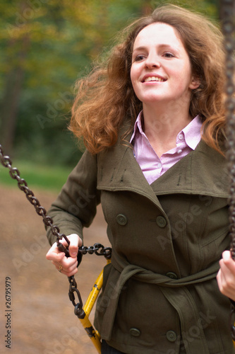 Smiling woman on swing