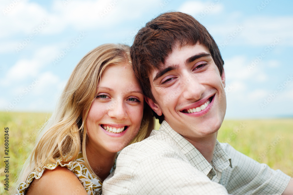 laughing happy couple over blue sky laughing happy couple over blue sky