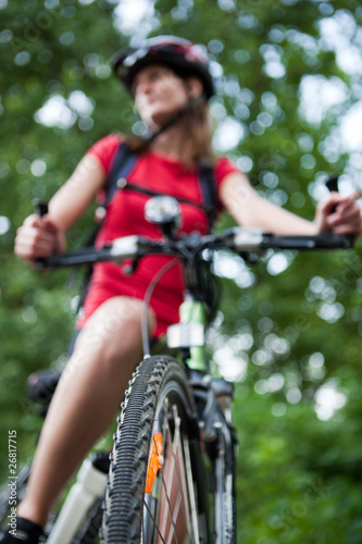 pretty young female biker outddors on her mountain bike (shallow
