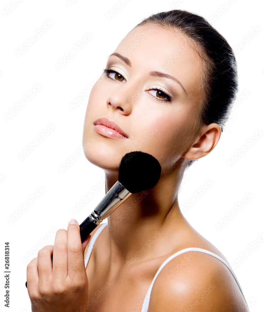 woman applying powder on forehead with brush woman applying powder on forehead with brush