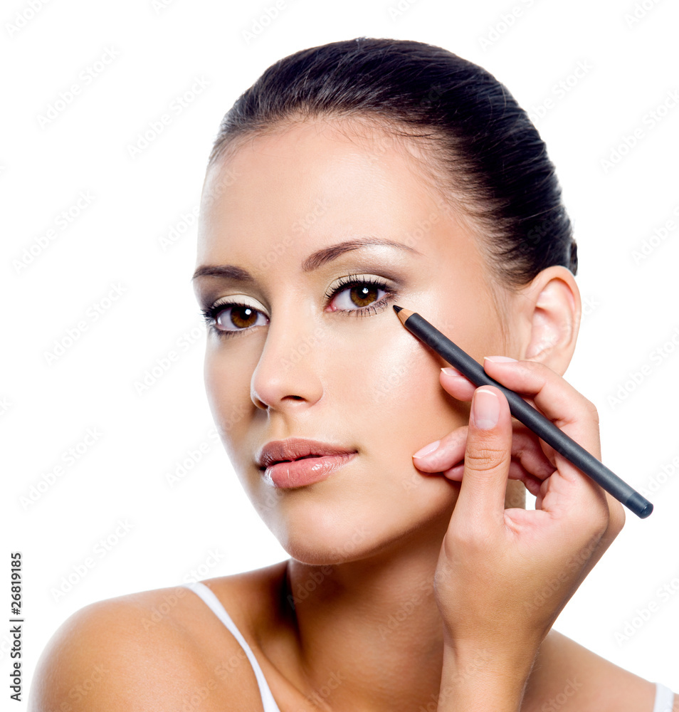woman applying eyeliner on eyelid with pensil woman applying eyeliner on eyelid with pensil