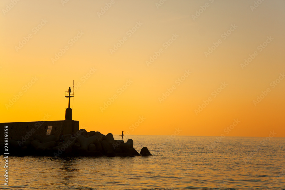 Silhouette Of Fisherman At Sunset