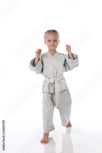 girl - karateka in a kimono on a white background