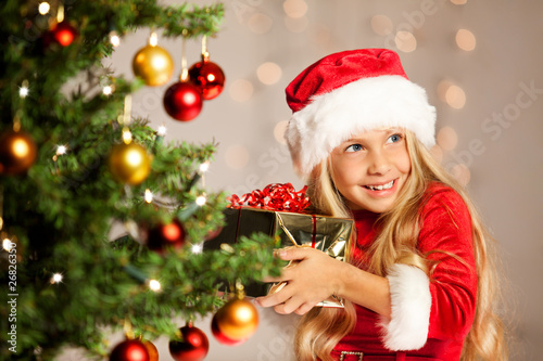 miss santa shaking a gift