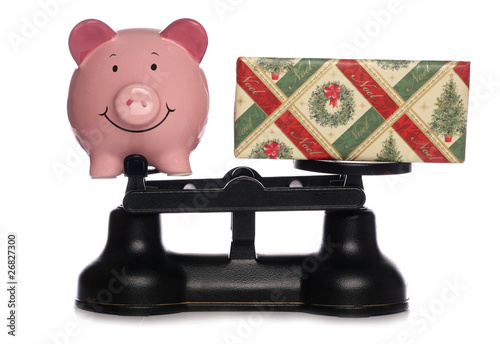 Christmas present and piggybank on scales photo