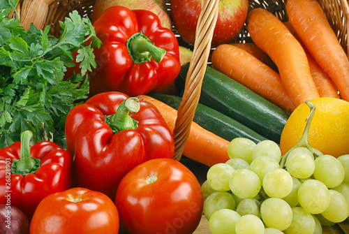 Composition with basket and vegetables on kitchen table