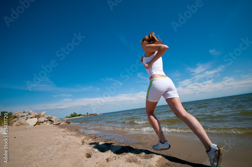 Sport woman running in sea coast