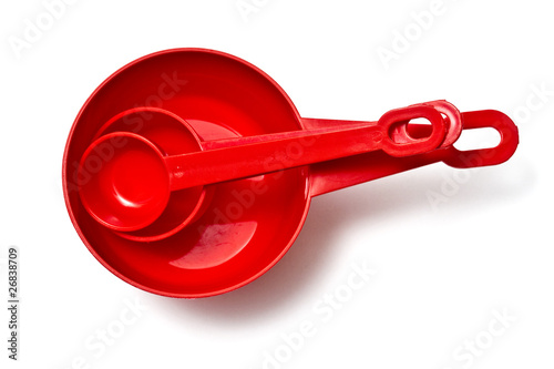 Set of red measuring cups isolated on white
