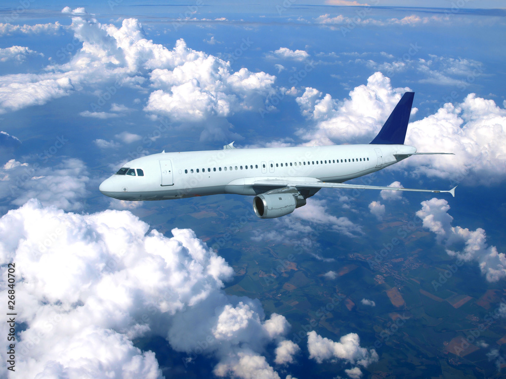 Obraz premium Airplane above clouds