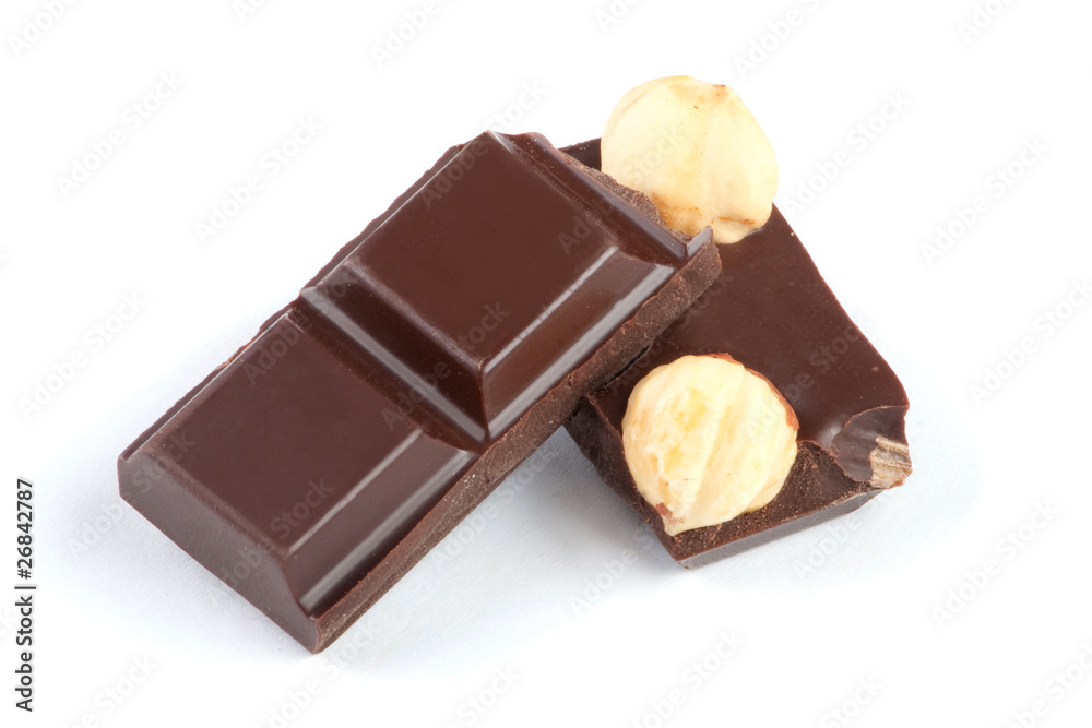Pieces of chocolate bar with nuts isolated on white Pieces of chocolate bar with nuts isolated on white