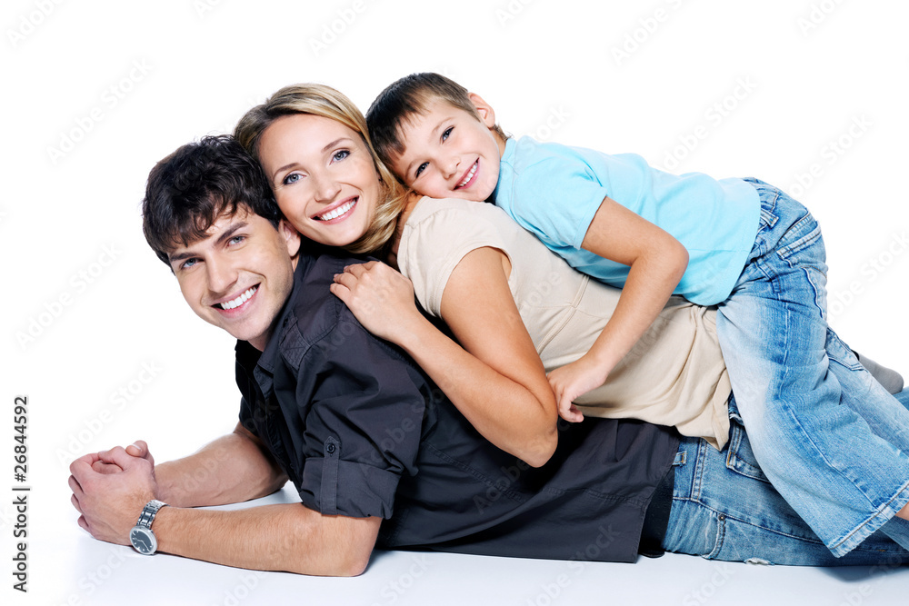 Happy beautiful family with child lying on floor Happy beautiful family with child lying on floor