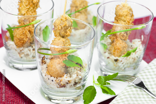 fried sausage balls with rice in a glass