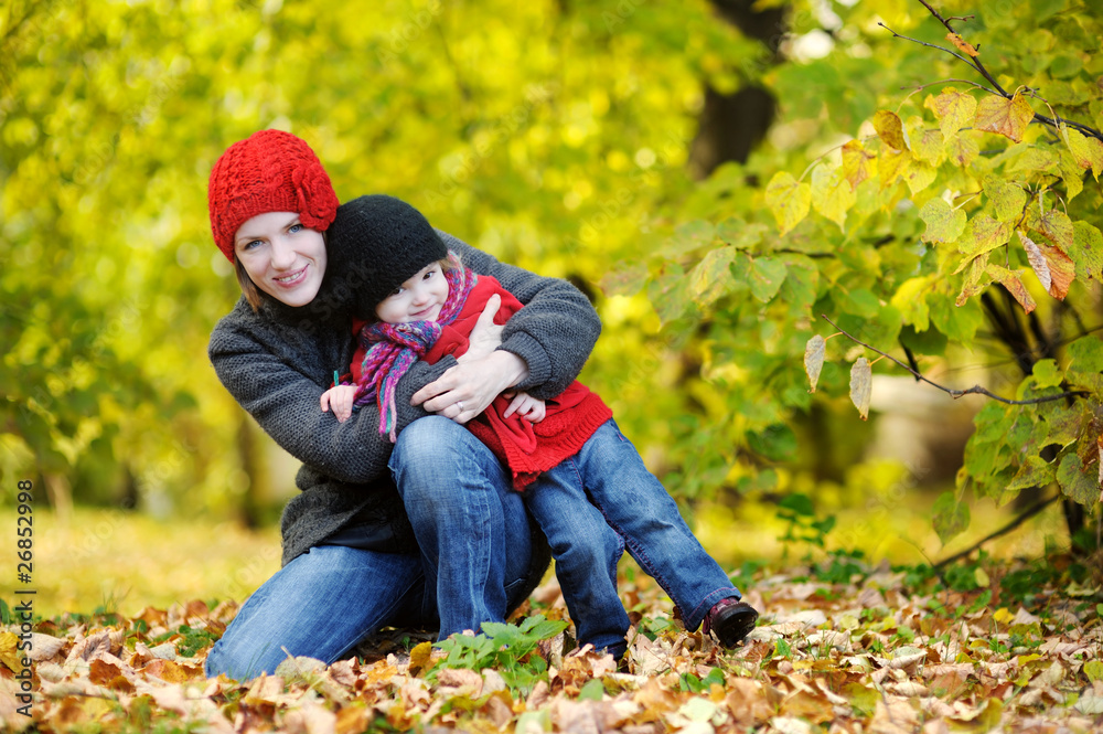 Young mother and her toddler girl in autumn Young mother and her toddler girl in autumn