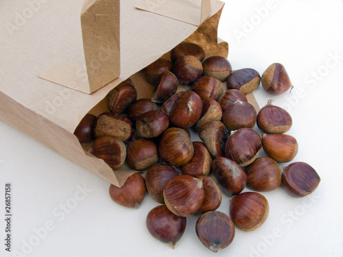 Chestnuts spilling out from a paper carrier bag