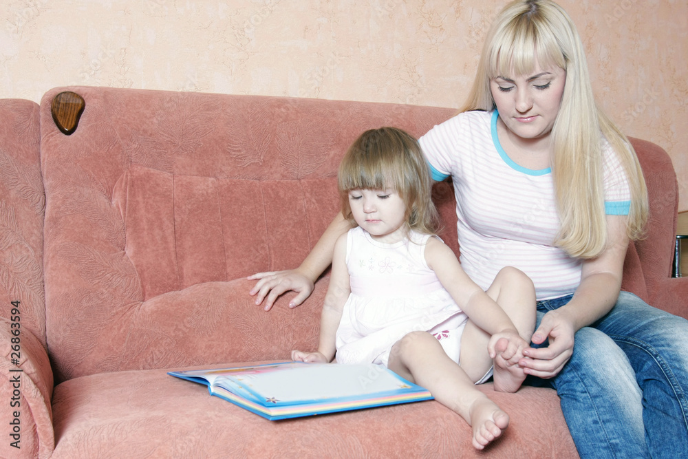mother and daughter reading book at home mother and daughter reading book at home