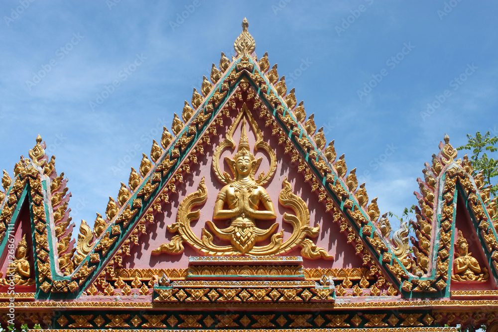Buddhist art on gable of archway of temple