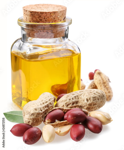 Photography bottle of peanut oil with nuts