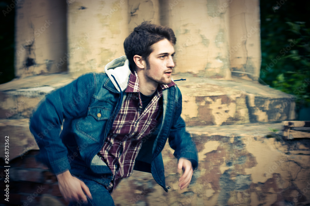 Obraz premium Young man wearing jeans clothes running