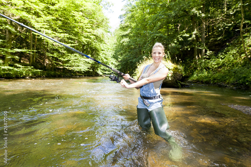 woman fishing in river woman fishing in river