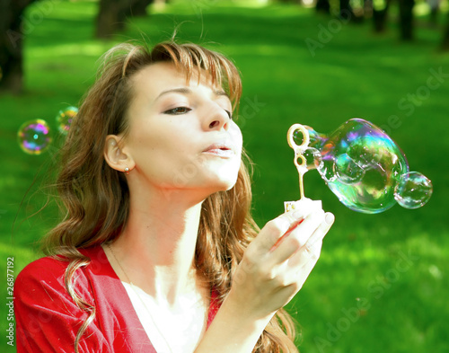 cute girl blowing soap bubbles