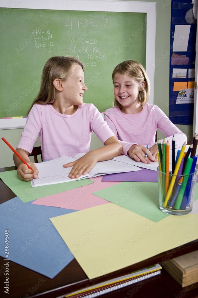 Girls in classroom doing schoolwork, writing Girls in classroom doing schoolwork, writing