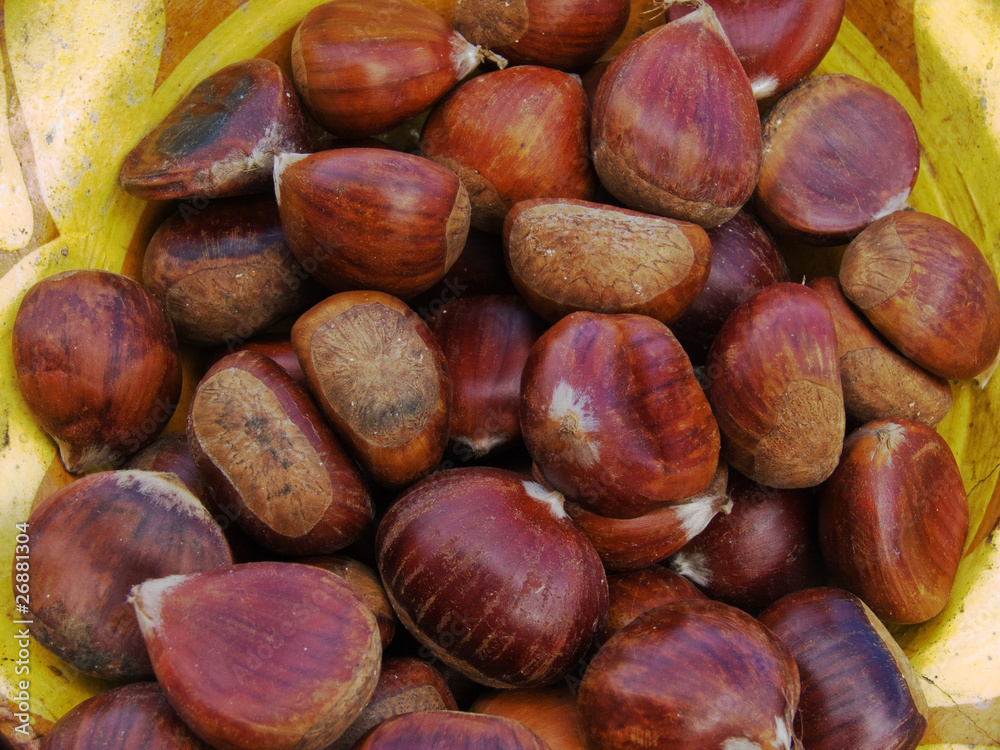 Chestnuts close up with partial mustard coloured bowl Chestnuts close up with partial mustard coloured bowl