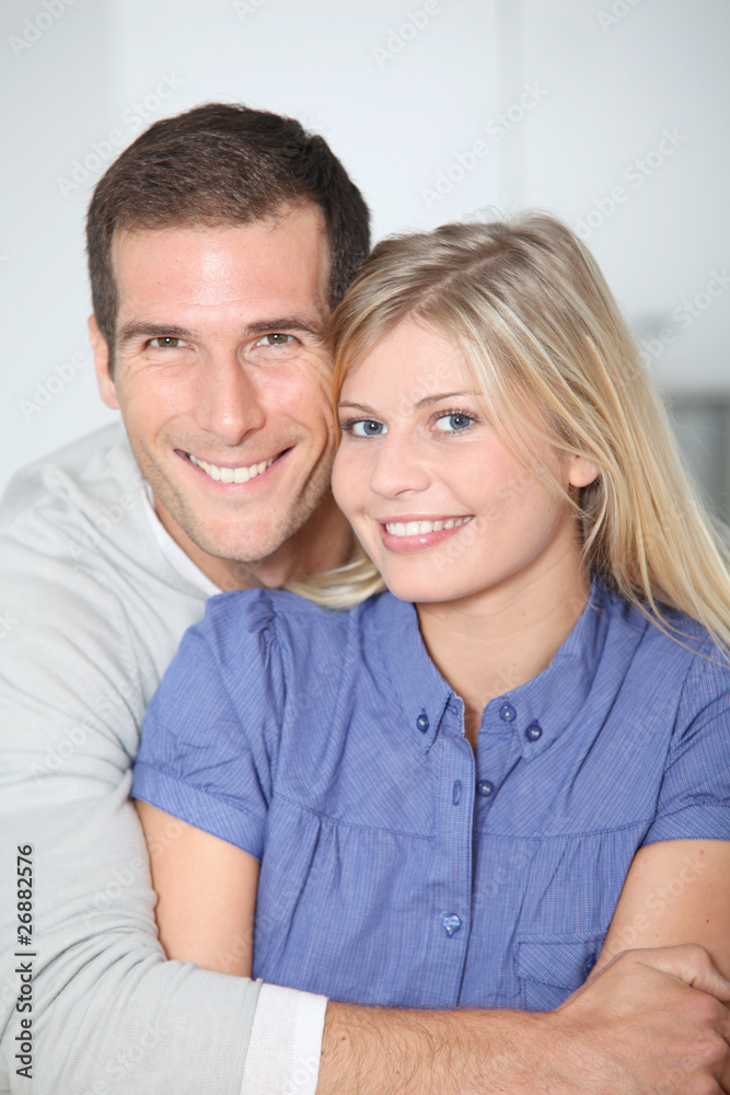 Smiling couple standing in home kitchen Smiling couple standing in home kitchen