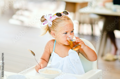 toddler girl have a breakfast