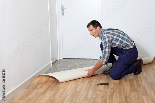 Closeup of artisan installing ground floor in room