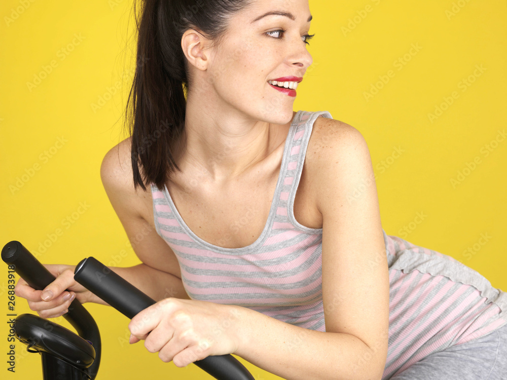 Young Woman Using Exercise Bike. Model Released