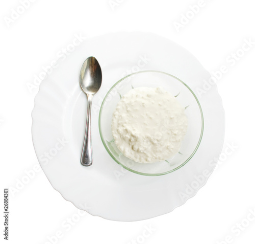 Bowl with cottage cheese on plate isolated with path