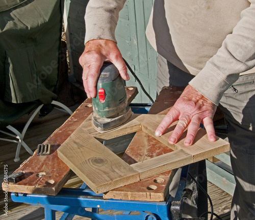 Sanding wood with an electric sanding tool