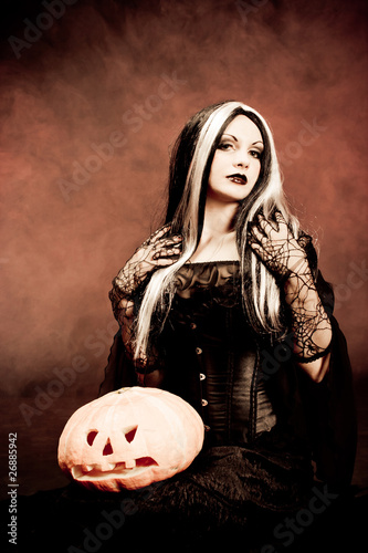 Halloween witch with a pumpkin