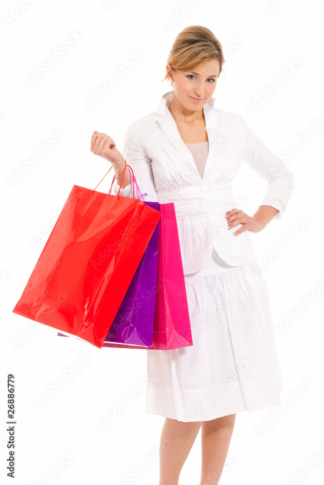 Young woman with shopping bags standing isolated on white Young woman with shopping bags standing isolated on white