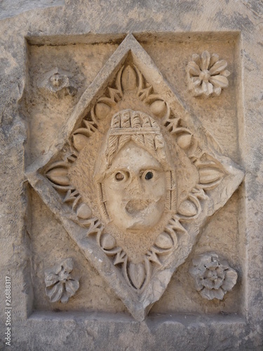 Myra Theater Stone Tablet roman stone carved face with flowers and dart and egg.