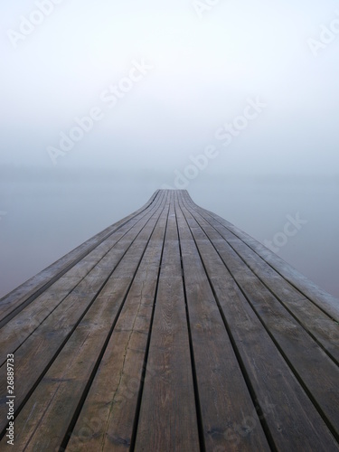 Jetty at a lake in foggy morning