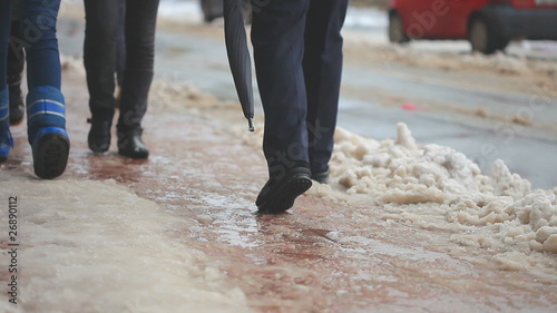 car driving and people walking on street in Winter and snow