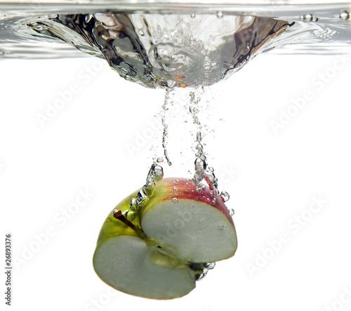 Fruit apple is dropped into water