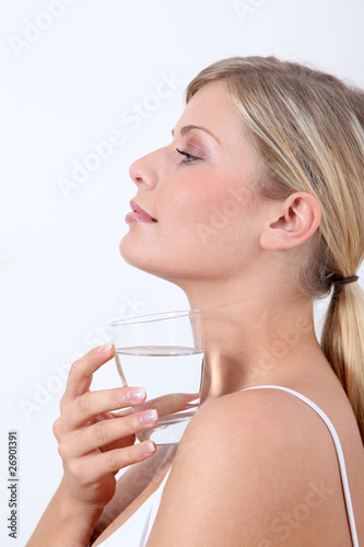 Closeup of woman holding glass of water