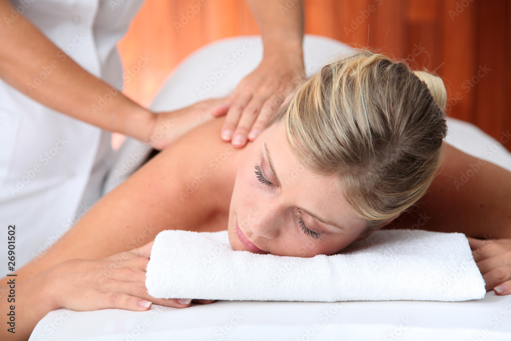 Closeup of beautiful woman laying on a massage bed Closeup of beautiful woman laying on a massage bed