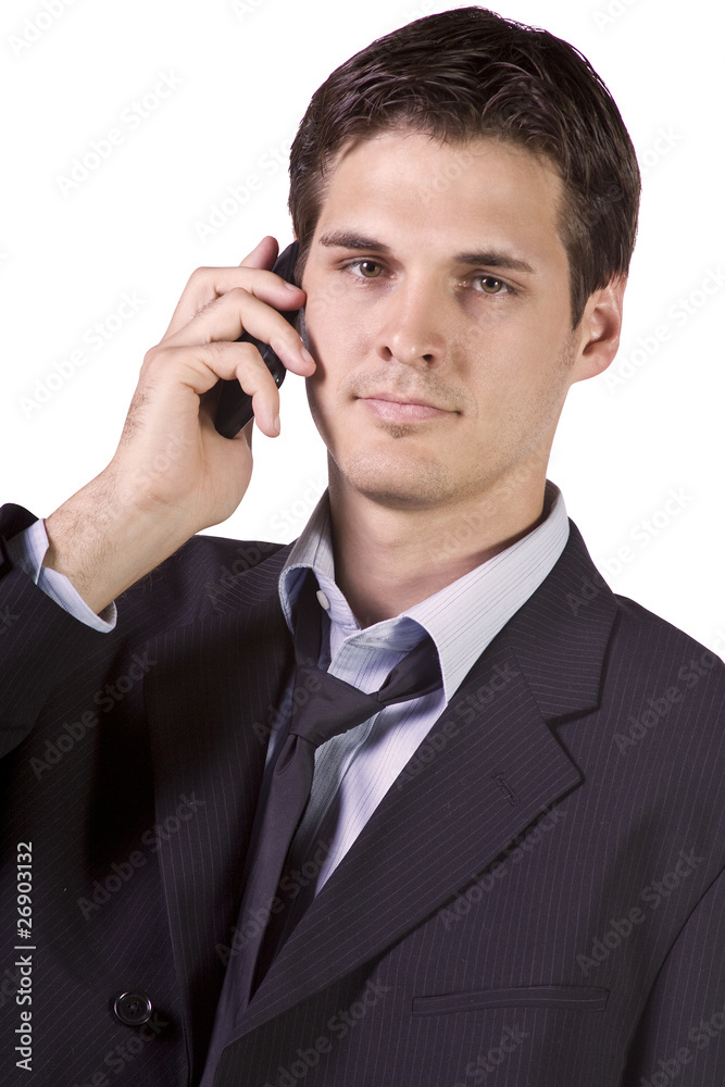 Young businessman conversing on cell phone Young businessman conversing on cell phone