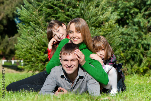 Happy parents and daughters in park